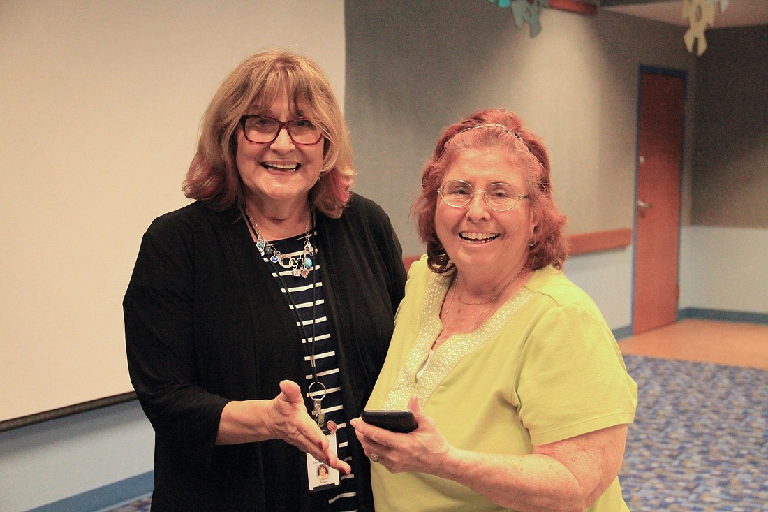 Judith Rossetti takes a photo with Liz, who declined to give her last name, after a discussion of cyber safety.