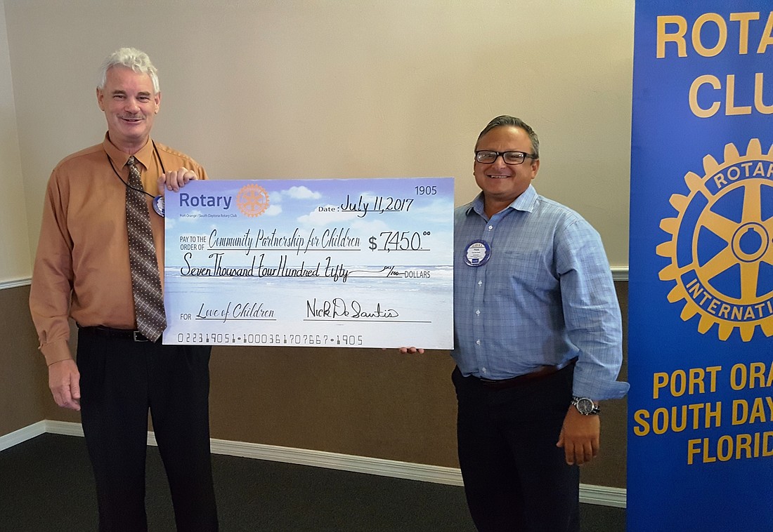 Nick DeSantis, president of the Rotary Club of Port Orange-South Daytona presents a check to Mark Jones, CEO of the Community Partnership for Children. Photo courtesy of the Rotary Club of Port Orange-South Daytona.
