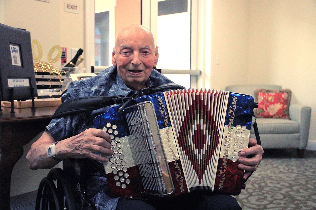 Ben Zaleski plays the accordion. Photo by Nichole Osinski.