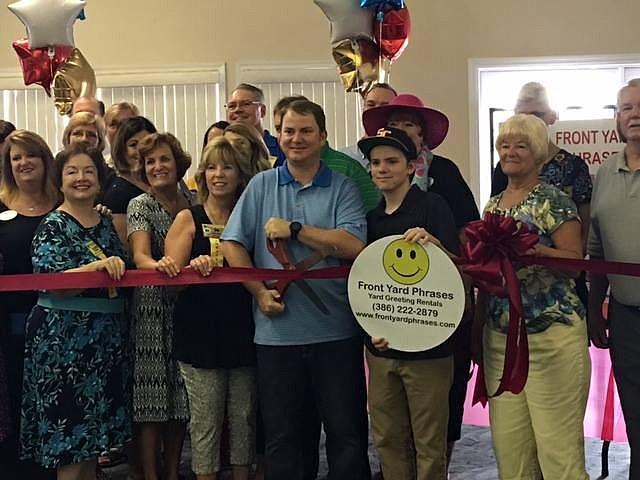 Dan Moyer cuts the ribbon to officially open his new business Front Yard Phrases. Photo courtesy of Dan Moyer.