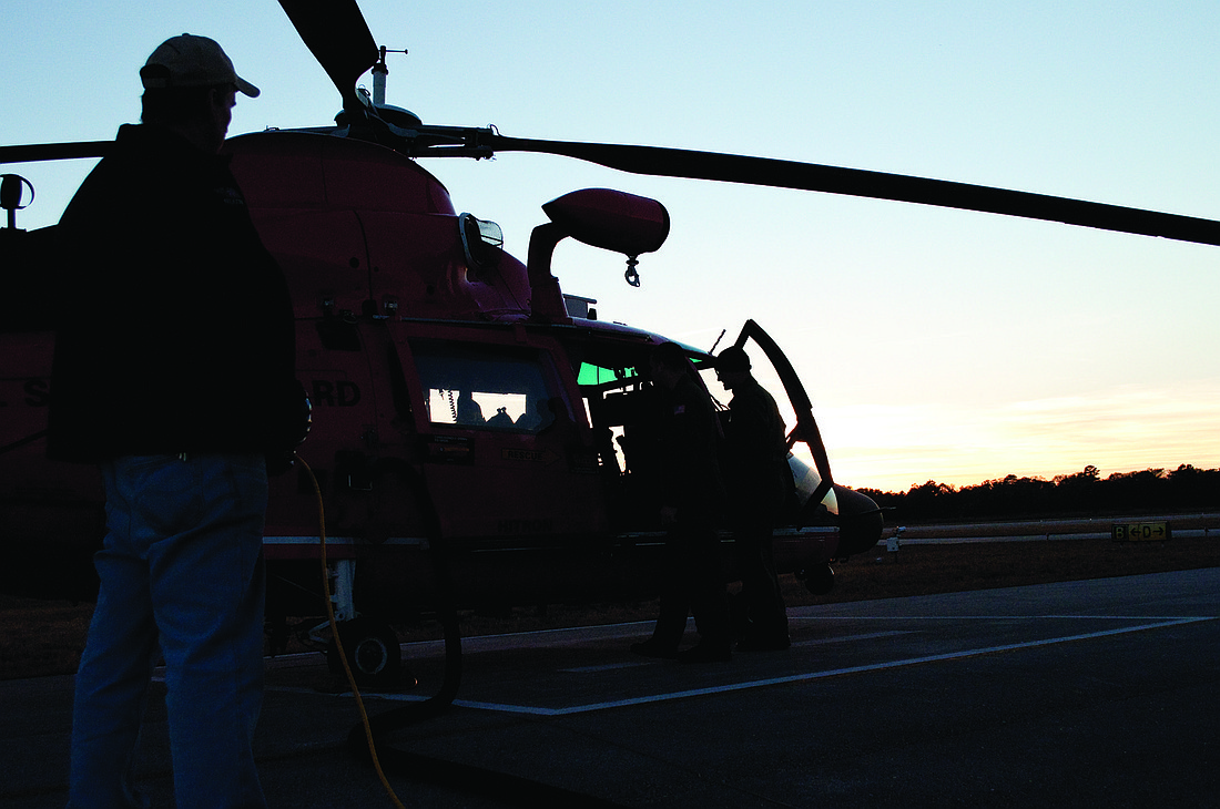 A Coast Guard helicopter lands at the airport.