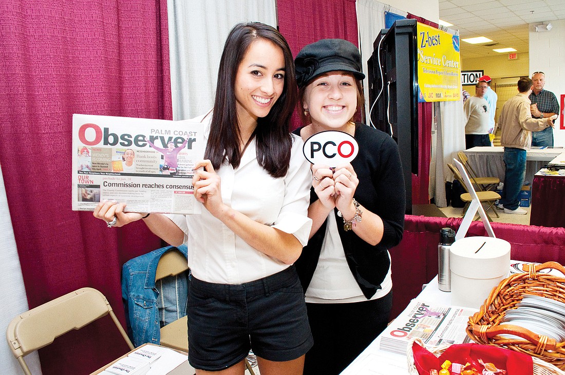 Natasha O'Conner and Mallorie Bruce work at the Palm Coast Observer booth at the home show. PHOTO BY SHANNA FORTIER