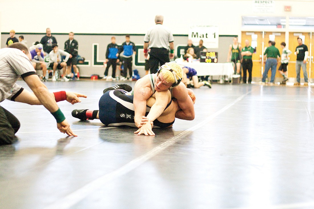 FPC 140-pounder Nick Michael gets direction from coach Bobby Bossardet during the preliminary round at the Region 1-3A championships Friday, Feb. 11. PHOTO BY ANDREW O'BRIEN