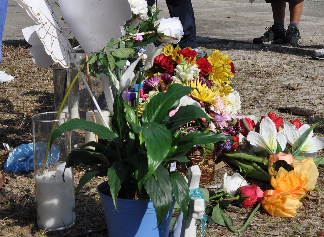 Mourners presented flowers at the site on Highway A1A, where Jigme Norbu was killed by car as he was walking for Tibet.
