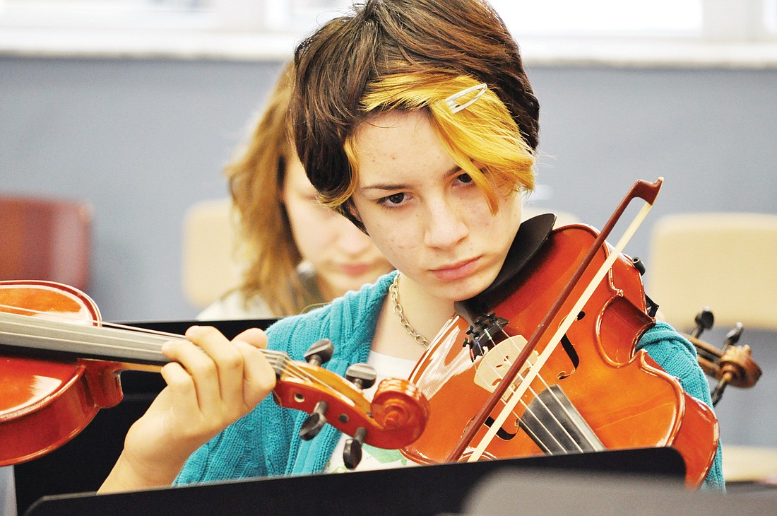 Kayla Tillman, a student in the Flagler Youth Orchestra, practices the viola Feb. 16, at Indian Trails Middle School, under the instruction of Caren Umbarger. PHOTOS BY ANDREW O'BRIEN