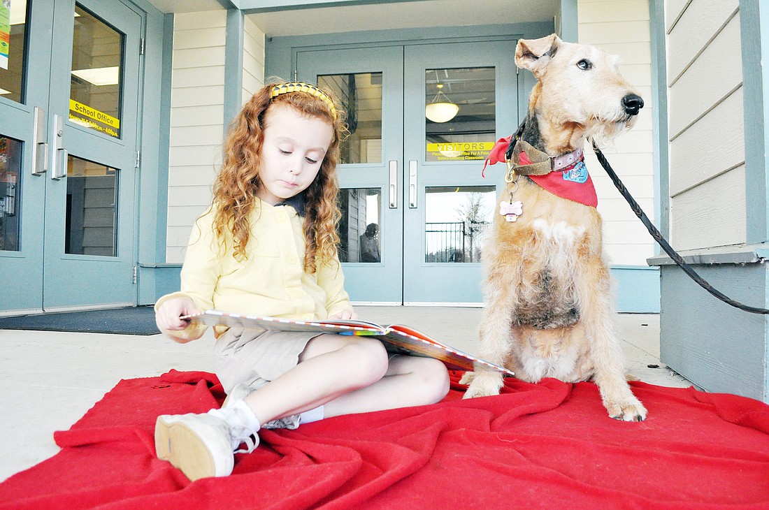 Sophia Papadakos reads the book, Ã¢â‚¬Å“Walter the Farting Dog: Banned from the Beach,Ã¢â‚¬Â to Daisy. PHOTO BY SHANNA FORTIER