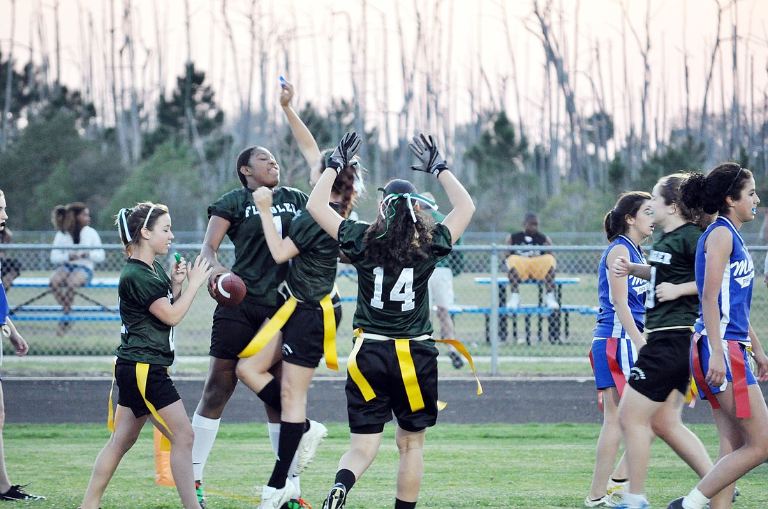 The Lady Bulldogs celebrate a touchdown with seconds to go in the first half. PHOTOS BY ANDREW O'BRIEN