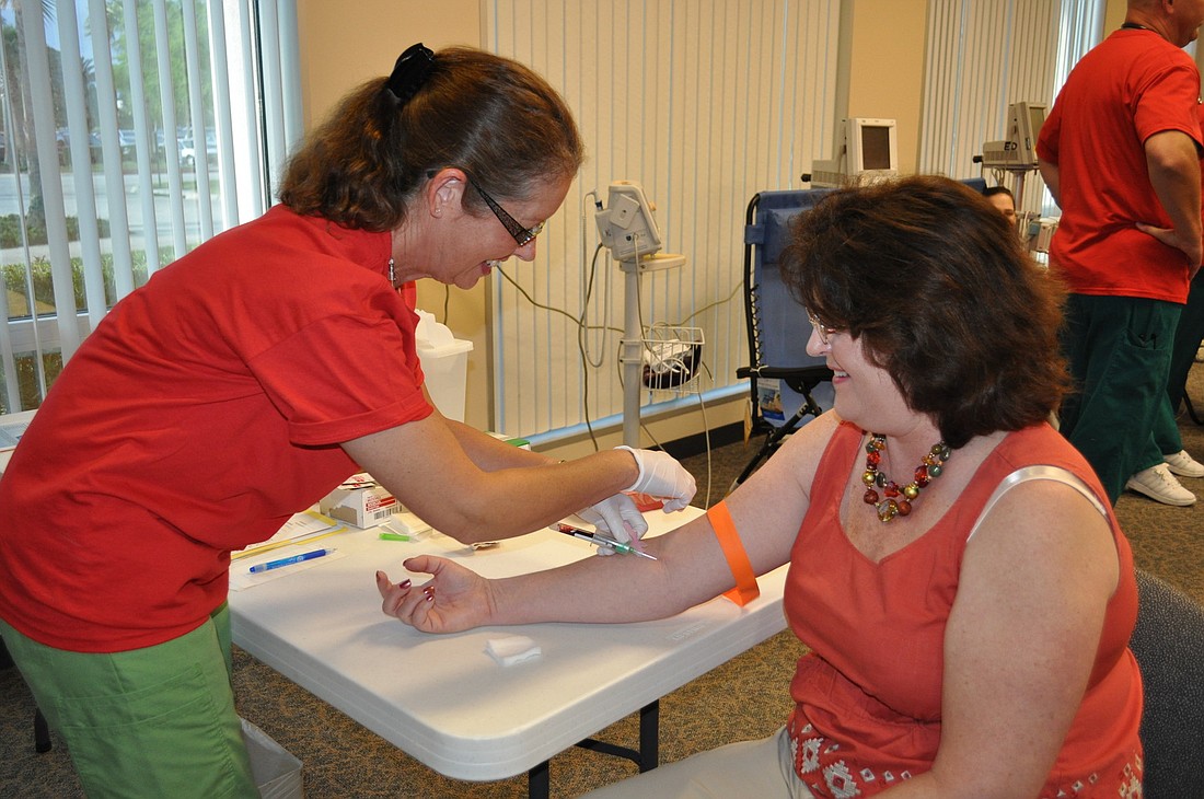 Palm Coast resident Linda Jarosz gets her blood taken Thursday, March 24, at the Florida Hospital Flagler Change Your Life Challenge screening.