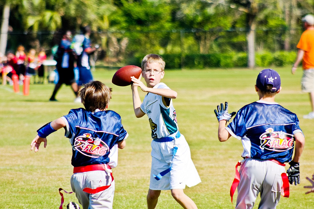 Ethan Christensen, 12,  plays quarterback for the Jaguars. PHOTO BY BRIAN MCMILLAN