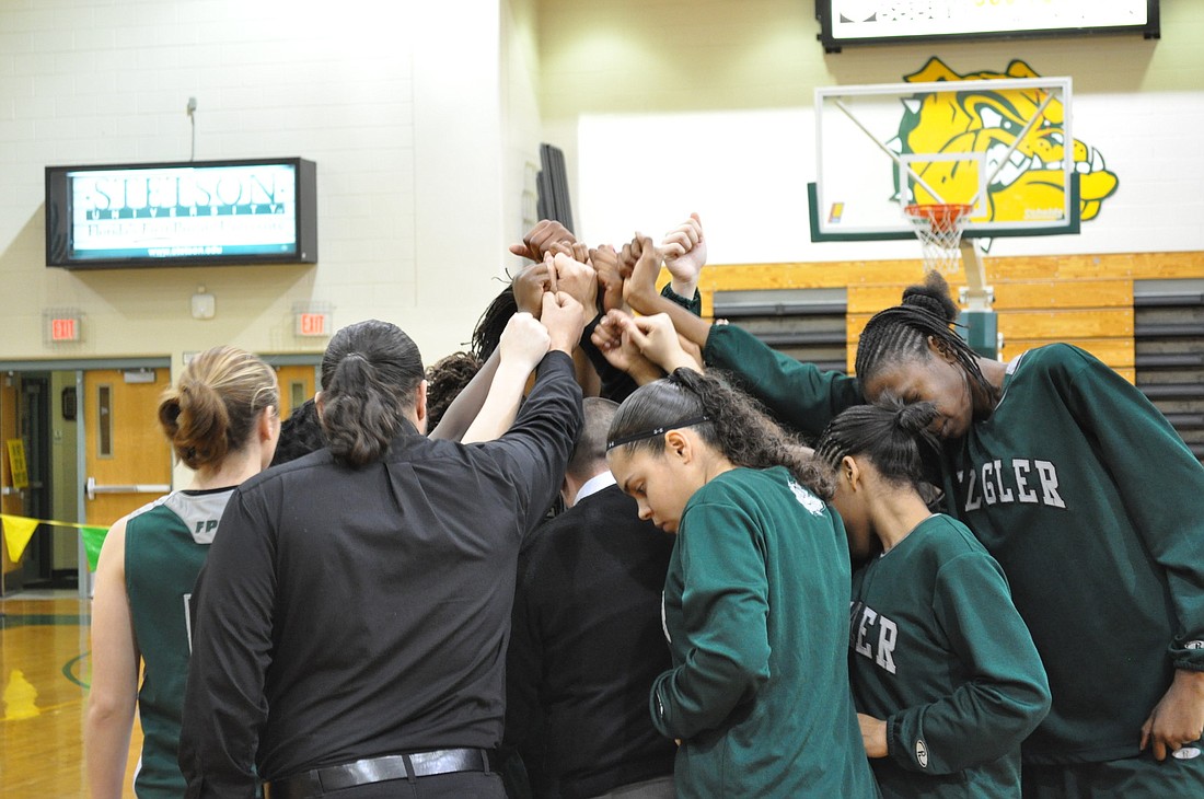FPC coach Javier Bevacqua huddles his team together in the second half of the district championship Saturday, Feb. 5.