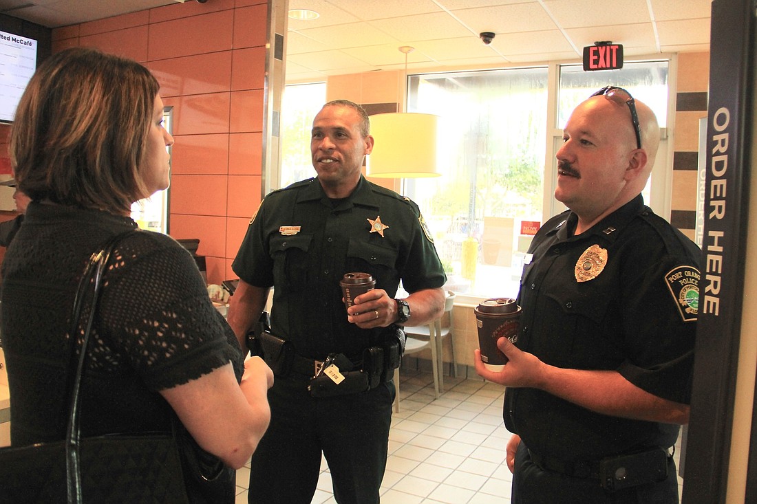 (L-R) Volusia County Sheriff's Office Division Chief Tim Morgan and Port Orange Police Patrol Capt. Scott Brozio speak with a resident during Coffee with a Cop. Photo by Nichole Osinski.