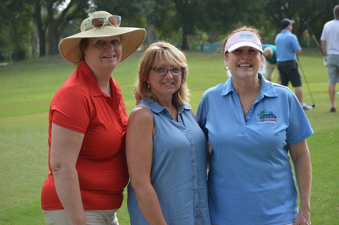 Deb McCall (left), Deb Donadio (center) and Debbie Connors (right) enjoy the festivites at the 22nd annual Port Orange-South Daytona Chamber of Commerce golf tournament.