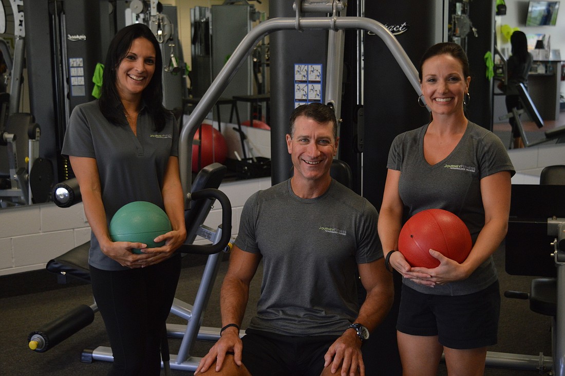 Office manager Heather King (left), co-owner Richard Boyd (center) and co-owner Mary Hall (right) pose for a photo at Journey Fitness Center. Photo by Tim Briggs.