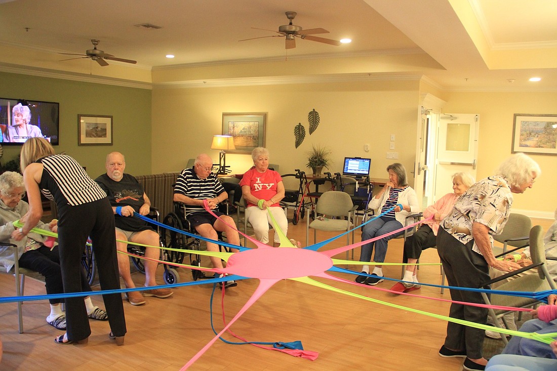 Residents do morning exercises. Photo by Nichole Osinski