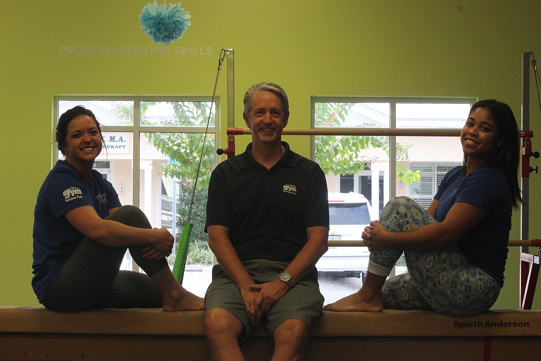 Assistant program director Chelsey Godbey, owner Eric Lancing and teacher Kiara Swint pose for a photo at Little Gym of Port Orange. Photo by Tim Briggs