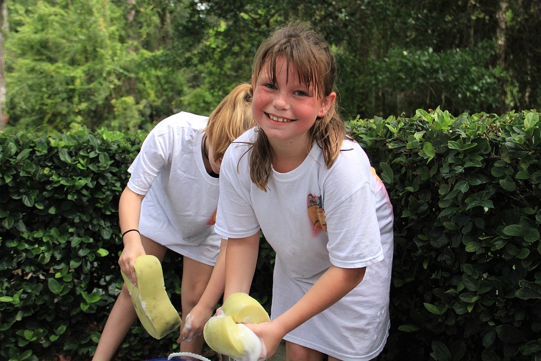 Phoenix Markoff helps out with the car wash. Photo by Nichole Osinski