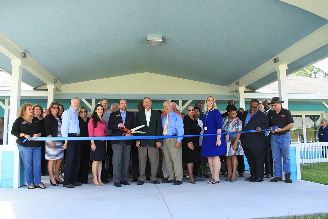 SMA CEOÂ Ivan Cosimi prepares to cut the ribbon at the Dr. James E. Huger Adolescent Campus. Photo by Nichole Osinski