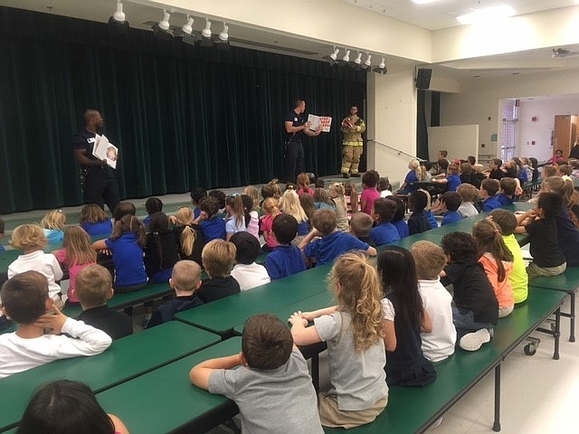 Firefighters talk with Cypress Creek Elementary students about fire safety. Photo courtesy of Port Orange Fire and Rescue