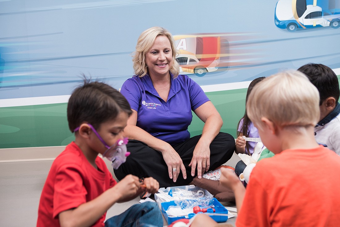 Nicole Baxa, a child life specialist at Florida Hospital Memorial Medical Center, works with children in the hospital. Photo courtesy of Florida Hospital East Florida Region