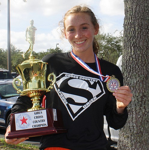Spruce Creek's Camryn Cooney poses with her trophy after winning the 5 Star Conference Championship. Cooney placed sixth in the regional meet. Photo courtesy of Kim Cooney