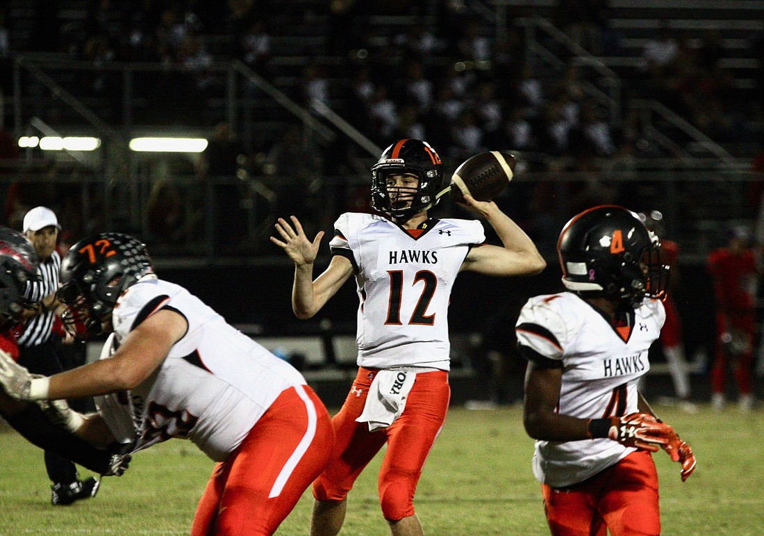 Spruce Creek quarterback Kyle Minckler attempts a pass against New Smyrna Beach. Photo by Ray Boone