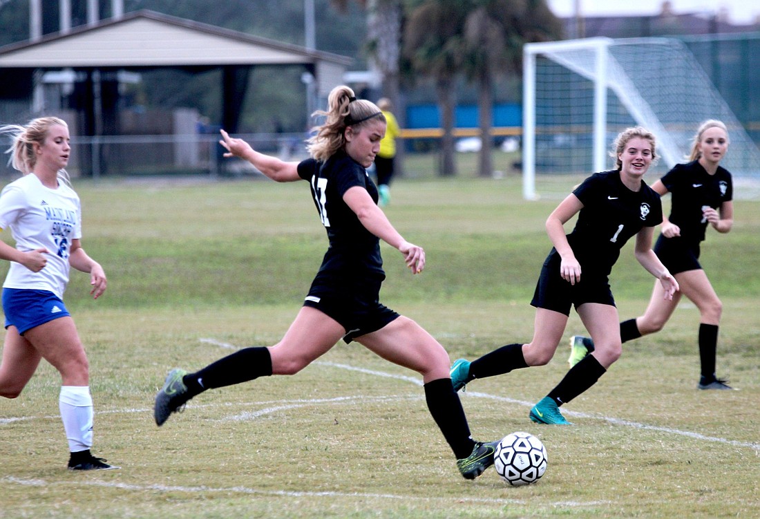 Spruce Creek's Ally Runge kicks a ball against Mainland. Photo by Ray Boone