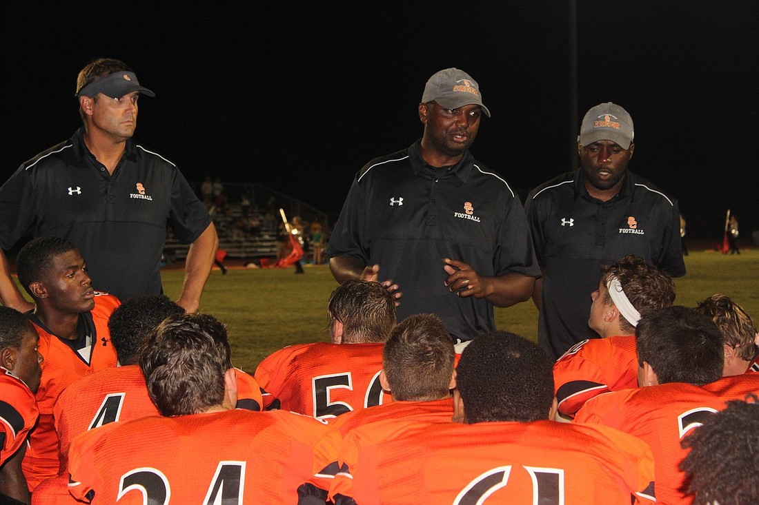 Former Spruce Creek defensive coordinator D.J. Mayo (middle) speaks to his team. Photo courtesy of D.J. Mayo
