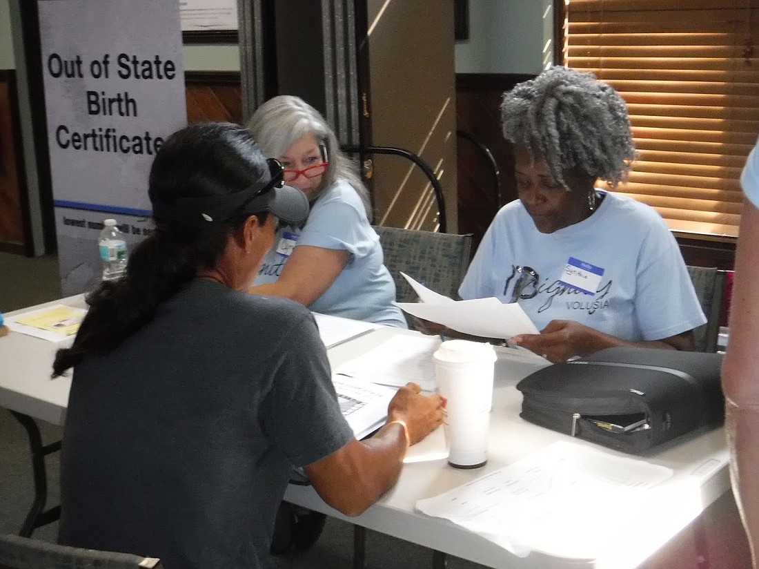 IDignity volunteers gather information from a client to apply for a copy of his out-of-state birth certificate during a July 2017 client event. Photo courtesy of Carolyn Fitzwilliam