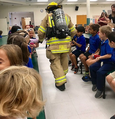 A firefighter gives a demonstration about fire safety to Cypress Creek Elementary students. Photo courtesy of Port Orange Fire and Rescue