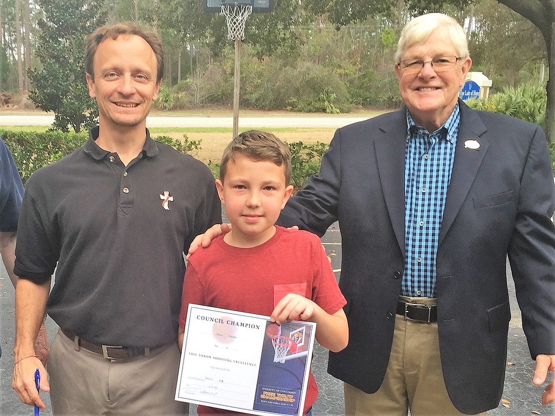 Mike Rosolio and Deputy Grand Knight Jim Waggoner with 14-year-old winner, Claire Carson. Photo courtesy of the Knights of Columbus