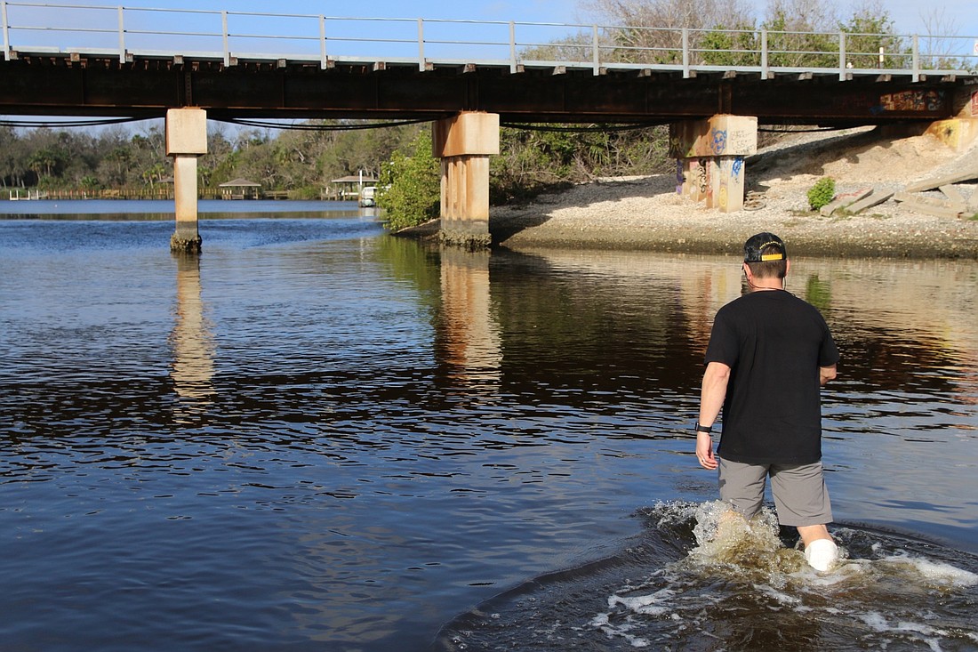 Robert Lloyd walks to the shore at Spruce Creek. Photo by Nichole Osinski