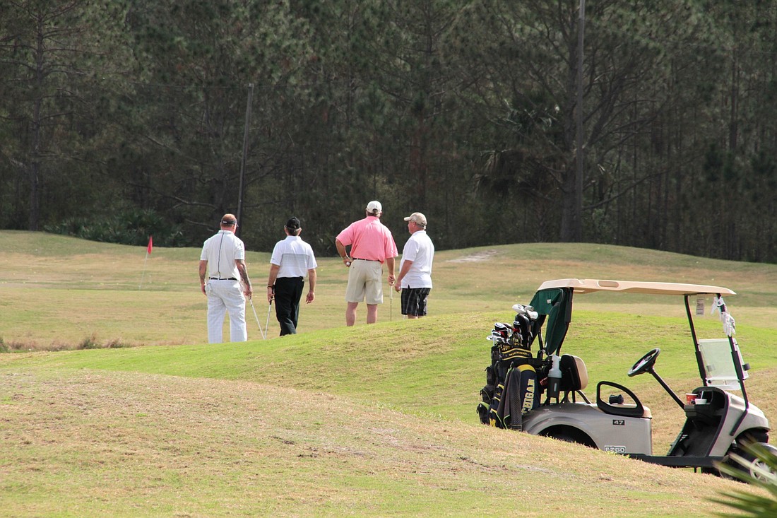 Golfers at Cypress Head Golf Course. Photo by Nichole Osinski