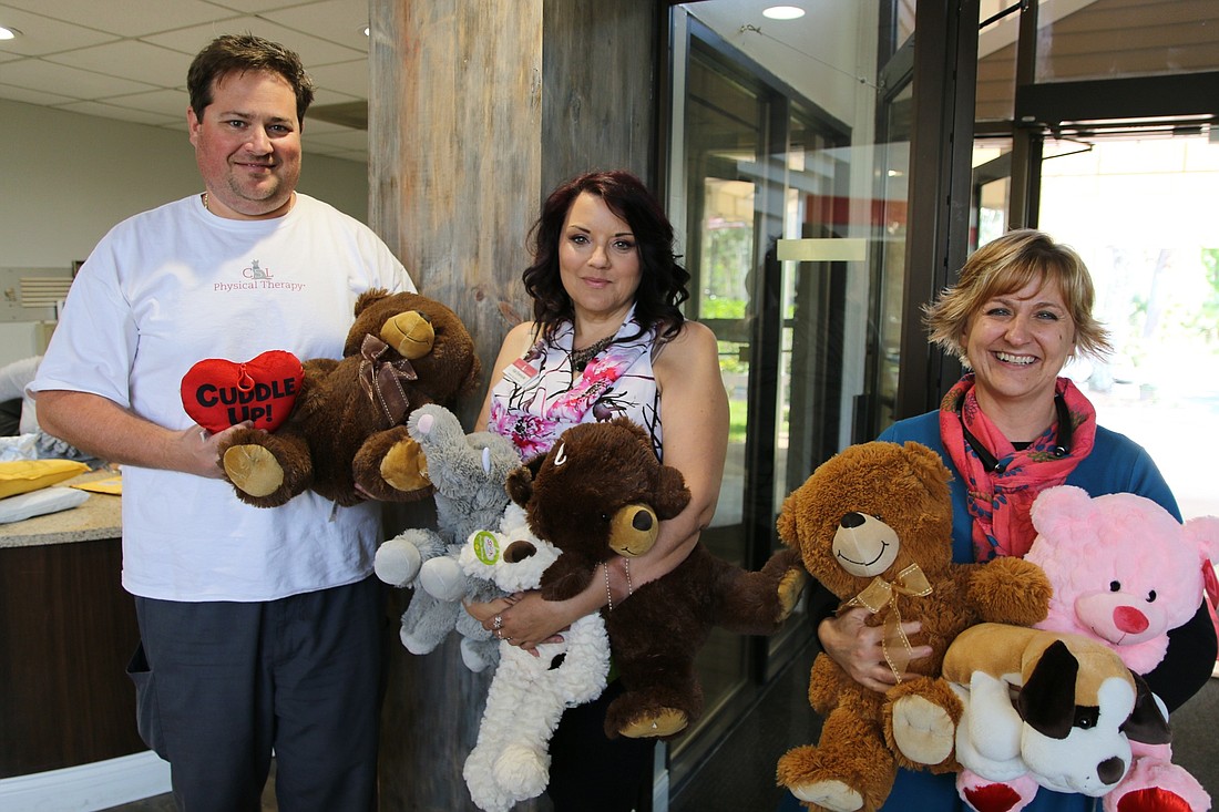 Kat Eversole holds a few of the teddy bears collected. Photo by Nichole Osinski