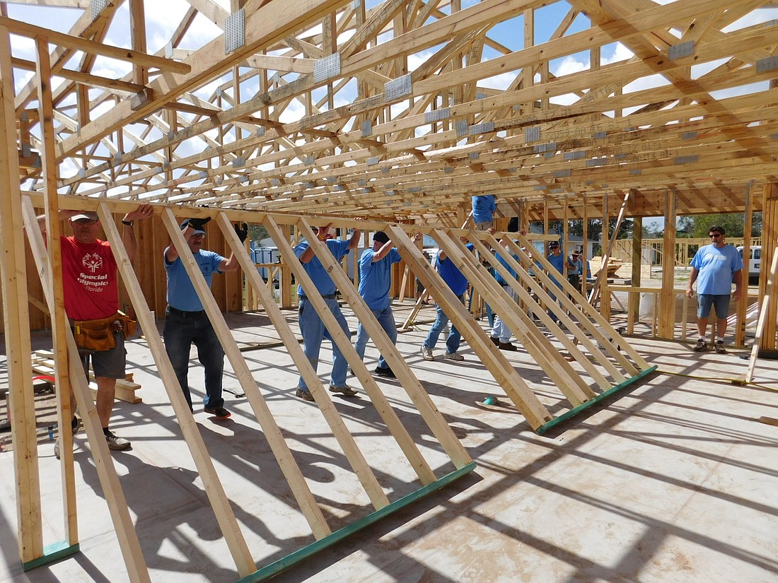 Members of the Knights of Columbus work with with Habitat for Humanity to build a home. Photo courtesy of Ted Morrell.