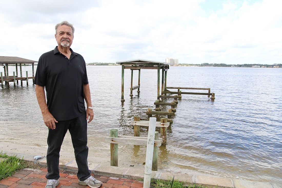 Stanley Escudero in front of the remains of his dock. Photo by Nichole Osinski