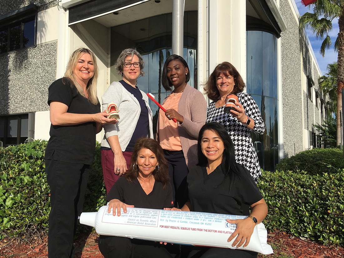 Department of Health helps children get dental care. Front: Patricia Foster and Priscilla Montijo, hygienists. Back: Trina Cowan, hygienist; Elin Grimes, nutritionist; Tachara Ferguson-Reid, manager; and Stacy Greenlaw, hygienist.