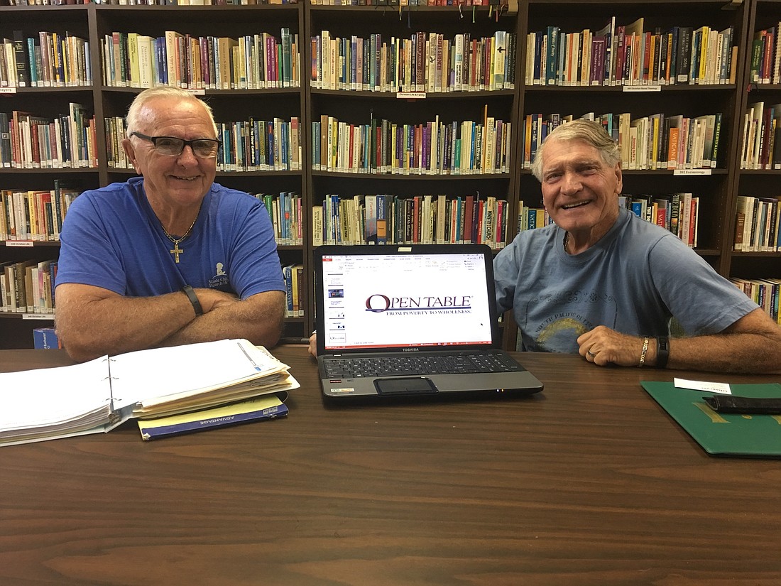 Bill Nilles and Joe Villanella, mission leaders, at the open table. Photo by Nichole Osinski