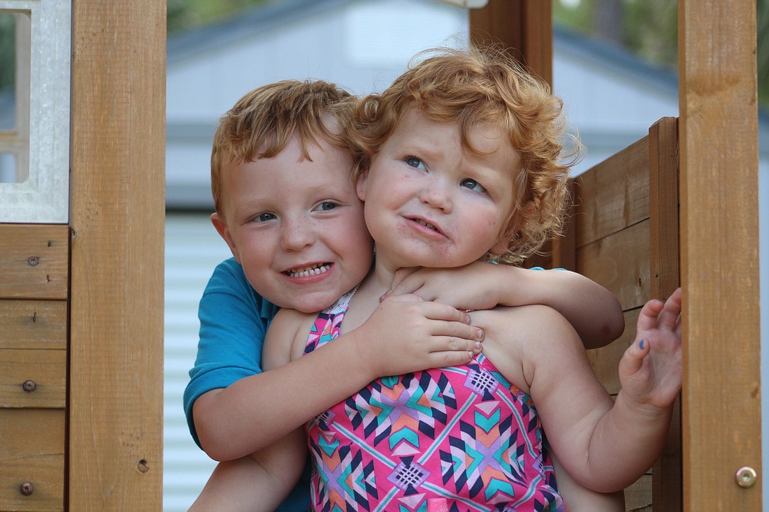 Kaeleigh, right, plays with her brother, Kaden, in their backyard. Photos by Lurvin Fernandez