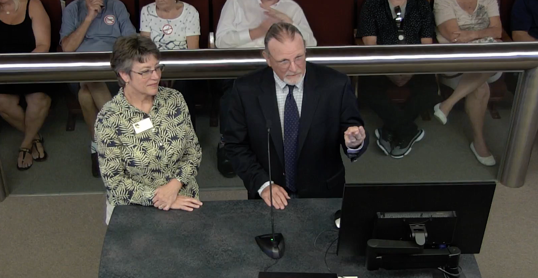 Linda Cuthbert, left, chairwoman for the Volusia County School Board, and Grek Akin, chief operating officer, explain the cost of the school guardian program.