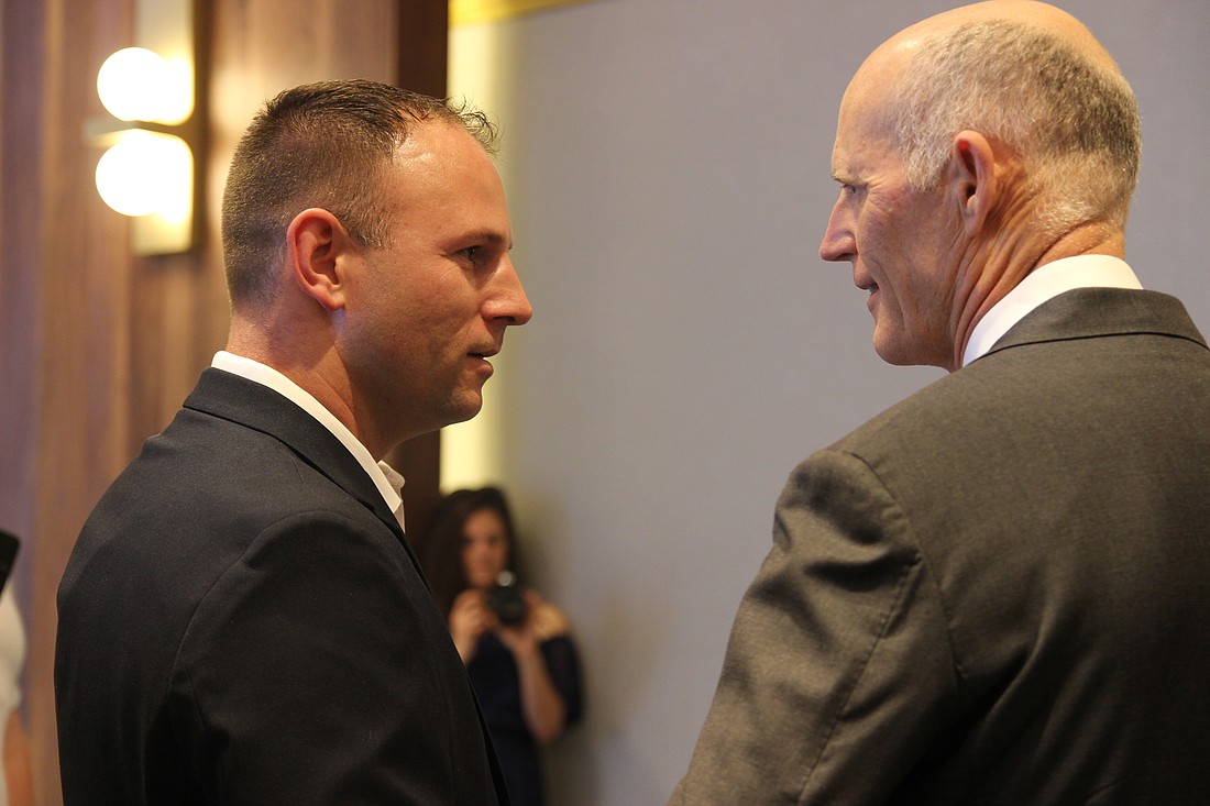 Port Orange City Councilman Chase Tramont shakes Rick Scott's hand during an event at the Hard Rock on May 4. Photo by Jarleene Almenas