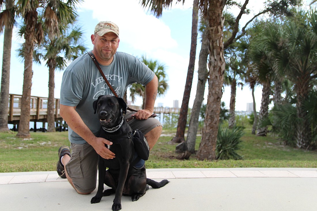 Jason Portell, a retired Navy veteran, with his service dog Slider.  Photos by Lurvin Fernandez