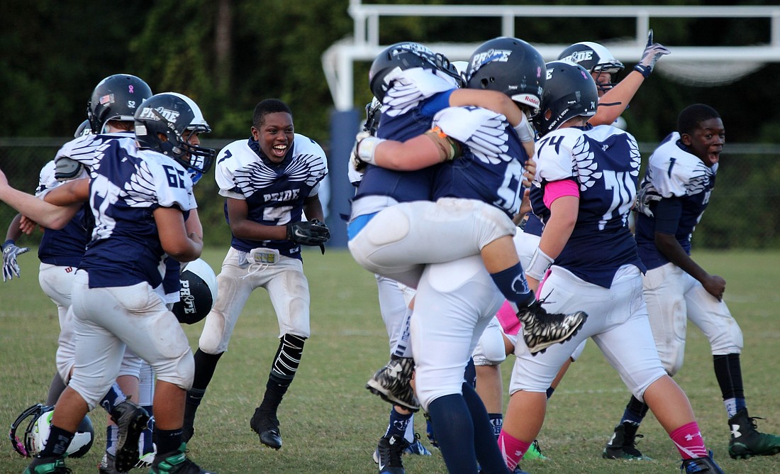 The Pride 12U team celebrated its 14-6 decision over the Gainesville Rattlers. Photos by Jeff Dawsey