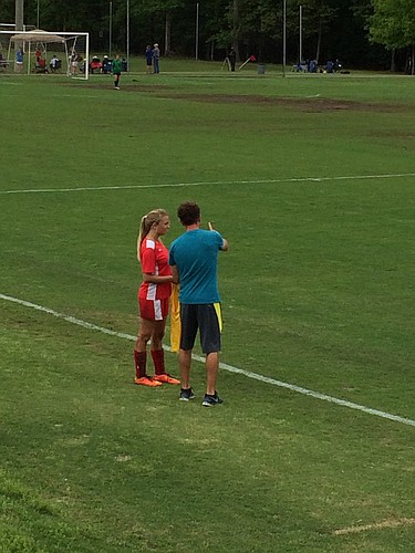 A coach gives instructions to a player.