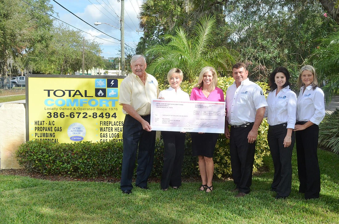 Total Comfort is a family-owned and operated business. Shown with the $7,027 check for Me Strong are Dan and Lynda Hucks, owners; Linda Ryan of Me Strong; Travis Hucks, son; Stacy King, daughter; and Michelle Lampro, daughter. Photo by Wayne Grant