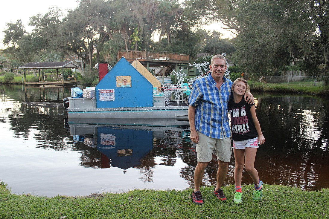 Buzzy Porter  and his daughter, 10-year-old Ryanne Porter pose for a photo, while his son, 14-year-old "Captain" Dawson Porter, keeps everything running on the boat (Photo by Emily Blackwood).