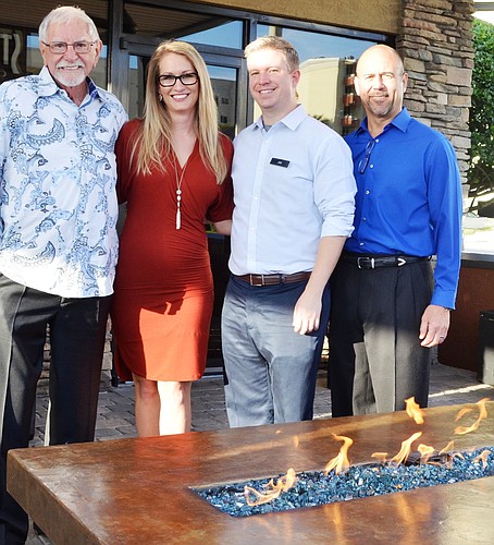 Shown by the fire pit in the new outdoor dining area are Gale Lemerand, CEO and president, Stonewood Holdings; Trish McGetrick, director of sales and marketing; Joe Clayton, regional manager; and Steve Papero, chief operating officer.