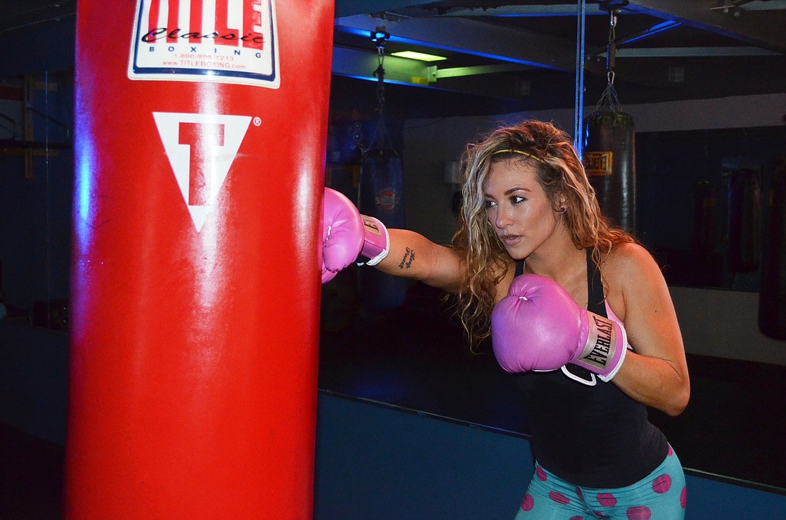 Trainer Lindsay Gray works out on the heavy bag at Evolution Health Club.