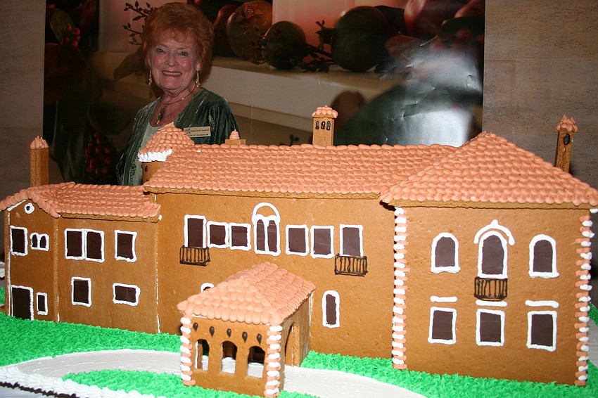 Event chair Natalie Gundrum and the Crosley Mansion rendered in gingerbread by Karl Schoenberger of the Old Heidelberg Bakery