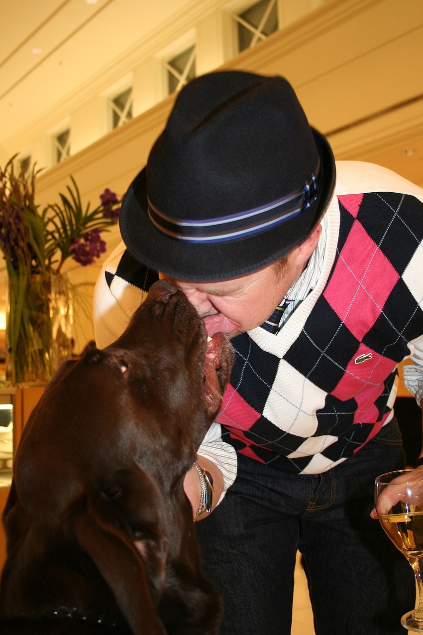 Hershey Hannum loves on Dave Weiner at Animal Rescue Coalition's 