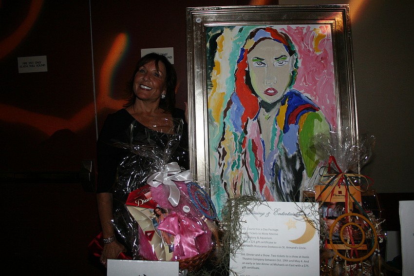 Marian Price poses by her painting.